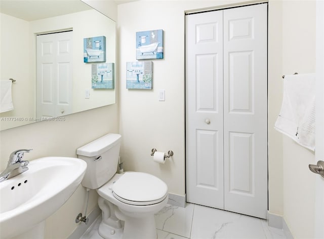 10572 W 35th Way, Hialeah, FL 33018 - bathroom featuring a closet and marble look tile flooring