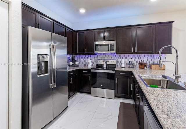 10572 W 35th Way, Hialeah, FL 33018 - kitchen with stainless steel appliances, dark brown cabinets, light stone counters, and light marble finish flooring