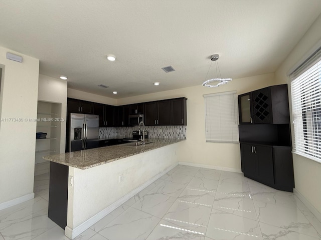 10572 W 35th Way, Hialeah, FL 33018 - kitchen featuring stainless steel appliances, light marble finish flooring, light stone countertops, tasteful backsplash, and a peninsula