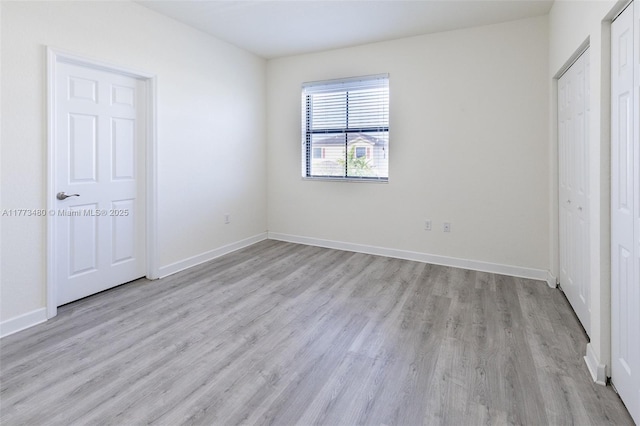 10572 W 35th Way, Hialeah, FL 33018 - unfurnished bedroom featuring light wood finished floors and baseboards