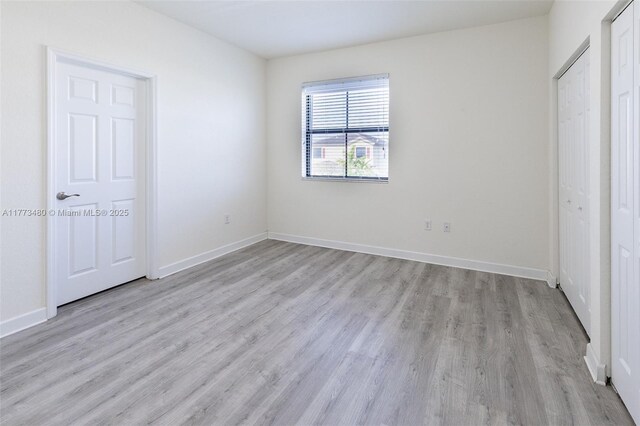 10572 W 35th Way, Hialeah, FL 33018 - unfurnished bedroom featuring light wood finished floors and baseboards