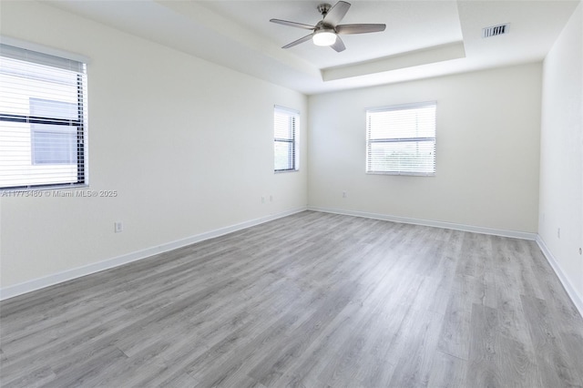 10572 W 35th Way, Hialeah, FL 33018 - spare room with a tray ceiling, ceiling fan, and light wood finished floors
