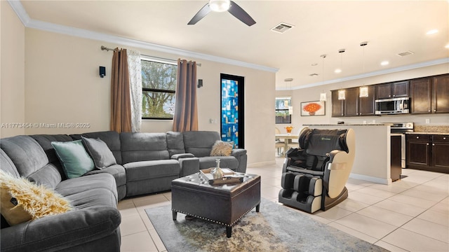 living area with light tile patterned floors, visible vents, and a healthy amount of sunlight