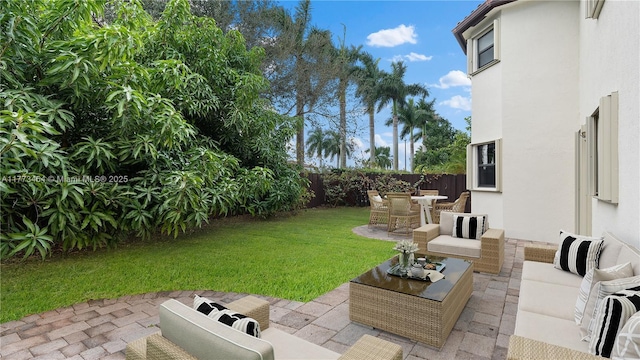 view of yard with a fenced backyard, an outdoor living space, a patio, and outdoor dining area