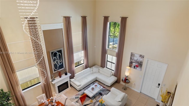 living area featuring light tile patterned floors and a towering ceiling