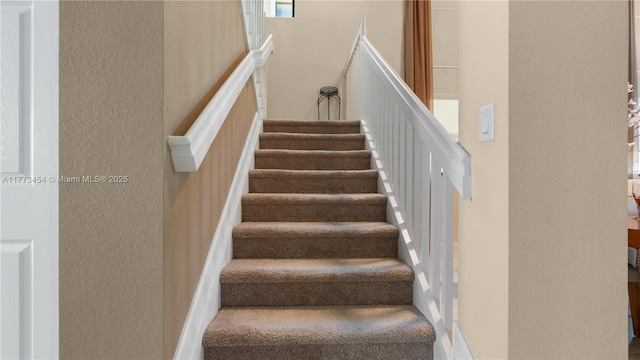 stairway with a textured wall