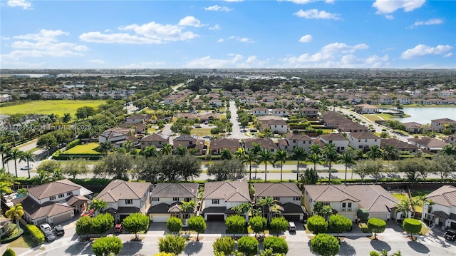 drone / aerial view featuring a water view and a residential view