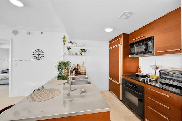 1850 S Ocean Dr Unit 1709, Hallandale Beach, FL 33009 - kitchen with visible vents, a sink, brown cabinets, black appliances, and light tile patterned flooring
