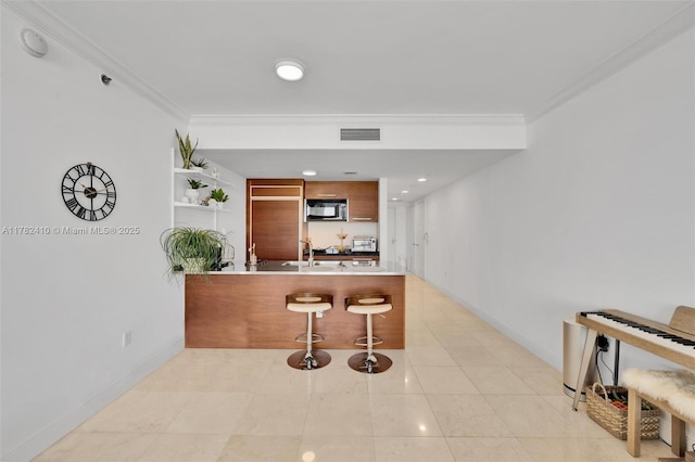 1850 S Ocean Dr Unit 1709, Hallandale Beach, FL 33009 - kitchen featuring baseboards, a breakfast bar, a peninsula, crown molding, and black microwave