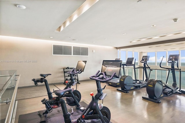 1850 S Ocean Dr Unit 1709, Hallandale Beach, FL 33009 - exercise room featuring a water view, baseboards, and a wall of windows