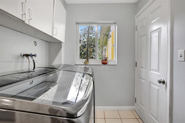 1780 SW 51st Ter, Plantation, FL 33317 - laundry area featuring separate washer and dryer, cabinet space, baseboards, and light tile patterned floors