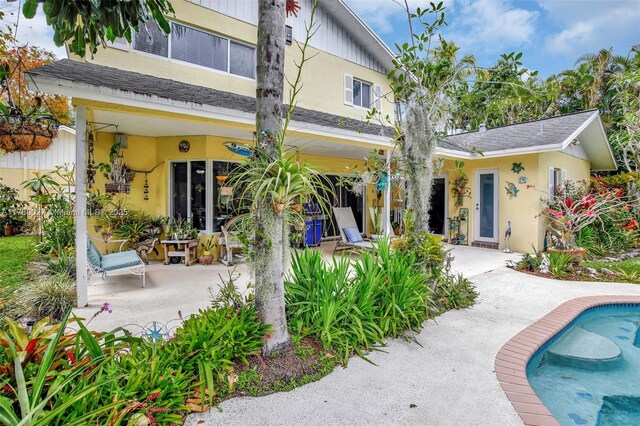 1780 SW 51st Ter, Plantation, FL 33317 - rear view of property with an outdoor pool, stucco siding, and a patio