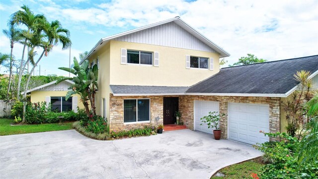 1780 SW 51st Ter, Plantation, FL 33317 - view of front of home with stone siding, concrete driveway, a garage, and a shingled roof