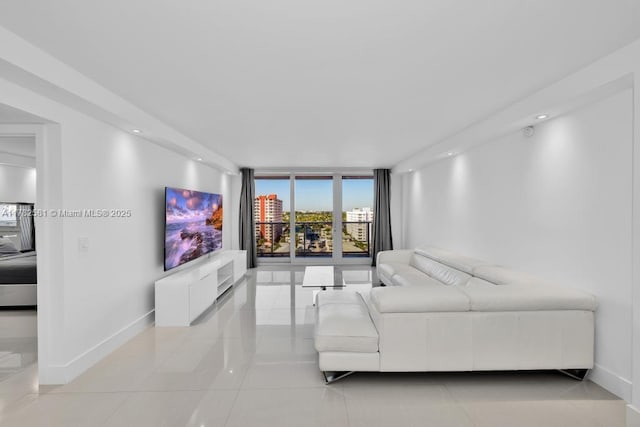 3140 S Ocean Dr Unit 1011, Hallandale Beach, FL 33009 - living room with light tile patterned flooring, baseboards, floor to ceiling windows, and recessed lighting