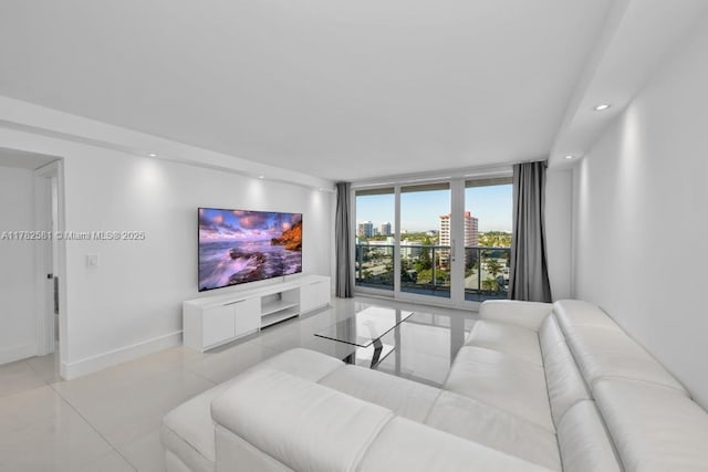 3140 S Ocean Dr Unit 1011, Hallandale Beach, FL 33009 - living room featuring floor to ceiling windows, recessed lighting, light tile patterned floors, and baseboards