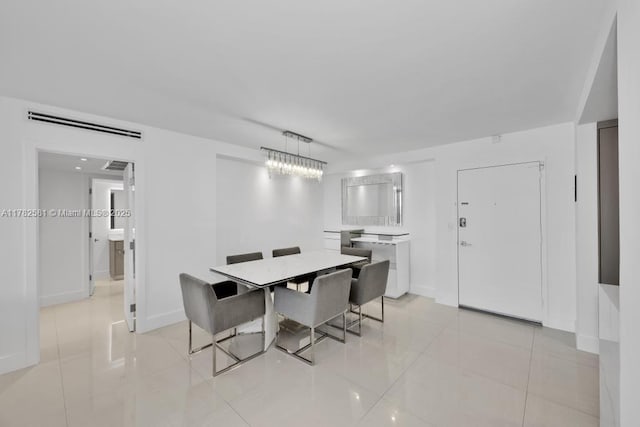 3140 S Ocean Dr Unit 1011, Hallandale Beach, FL 33009 - dining area featuring light tile patterned floors, baseboards, and an inviting chandelier