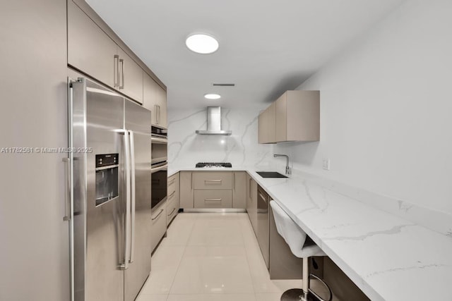 3140 S Ocean Dr Unit 1011, Hallandale Beach, FL 33009 - kitchen featuring a sink, wall chimney range hood, light stone countertops, gray cabinets, and stainless steel appliances