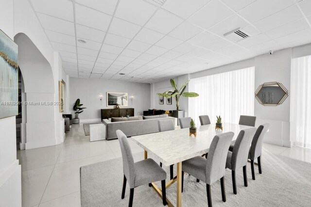 3140 S Ocean Dr Unit 1011, Hallandale Beach, FL 33009 - dining space featuring visible vents, a drop ceiling, and light tile patterned floors