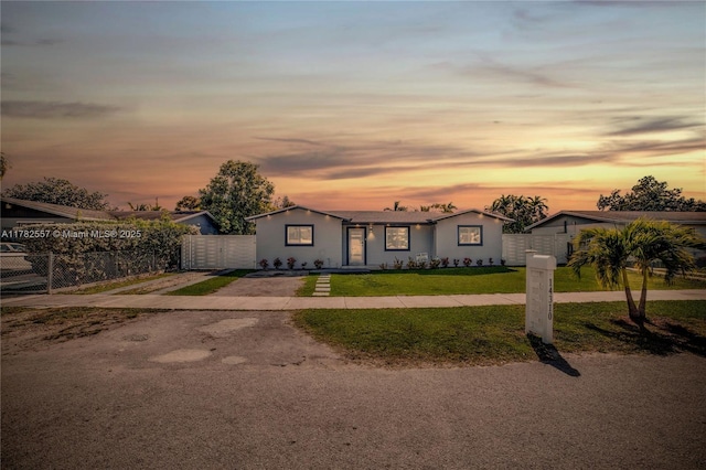 14310 SW 289th St, Homestead, FL 33033 - view of front of property featuring a gate, driveway, fence, a yard, and stucco siding