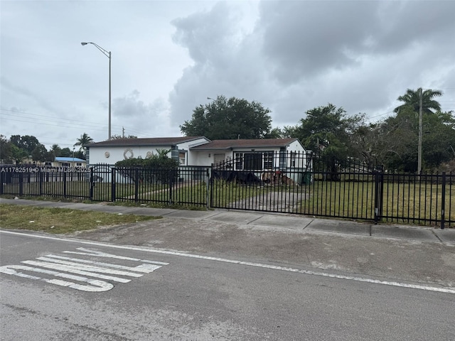 18300 NW 10th Ct, Miami Gardens, FL 33169 - view of gate featuring a lawn and a fenced front yard