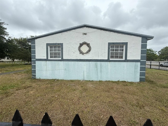 18300 NW 10th Ct, Miami Gardens, FL 33169 - view of home's exterior featuring a yard, stucco siding, and fence