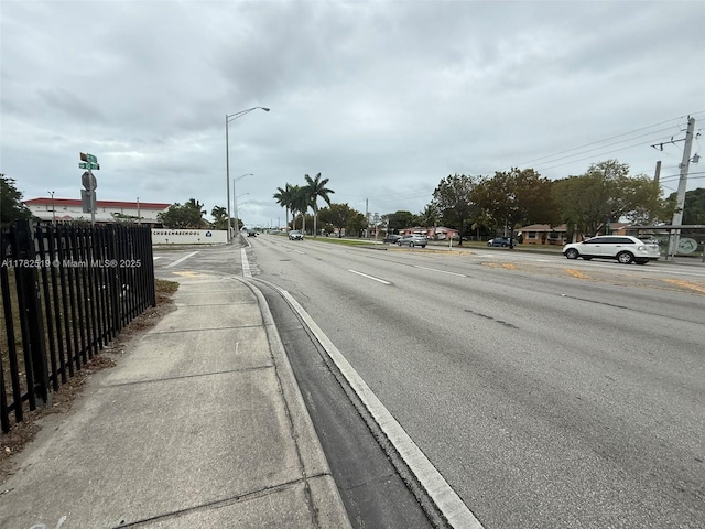18300 NW 10th Ct, Miami Gardens, FL 33169 - view of street with street lighting, sidewalks, and curbs