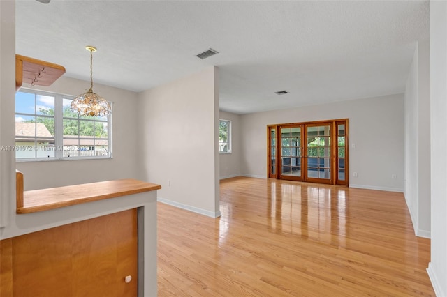 16901 SW 89th Ave, Palmetto Bay, FL 33157 - interior space with a notable chandelier, light wood finished floors, visible vents, and baseboards