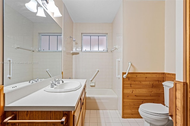 16901 SW 89th Ave, Palmetto Bay, FL 33157 - bathroom with washtub / shower combination, toilet, vanity, wainscoting, and tile patterned flooring