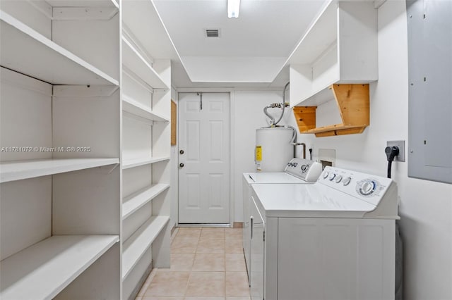 16901 SW 89th Ave, Palmetto Bay, FL 33157 - clothes washing area with water heater, separate washer and dryer, light tile patterned flooring, visible vents, and laundry area