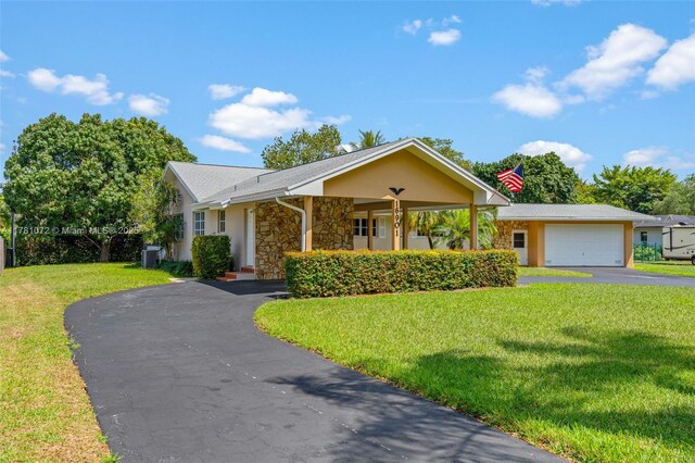 16901 SW 89th Ave, Palmetto Bay, FL 33157 - ranch-style house featuring an attached garage, driveway, a front yard, and stucco siding