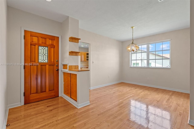 16901 SW 89th Ave, Palmetto Bay, FL 33157 - entrance foyer with a chandelier, light wood-style flooring, and baseboards