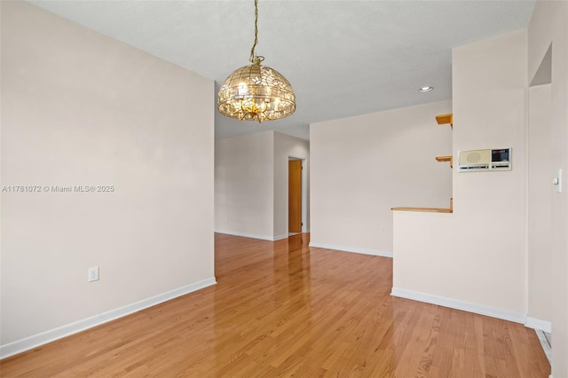 16901 SW 89th Ave, Palmetto Bay, FL 33157 - empty room featuring baseboards, light wood-type flooring, and an inviting chandelier