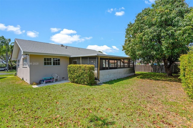 16901 SW 89th Ave, Palmetto Bay, FL 33157 - back of house featuring fence, a sunroom, a lawn, and stucco siding