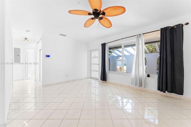 unfurnished room with ceiling fan, baseboards, tile patterned floors, and visible vents