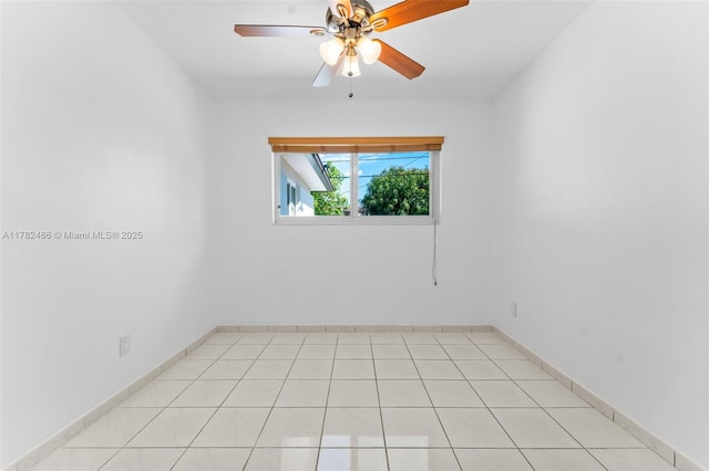 unfurnished room featuring a ceiling fan and baseboards