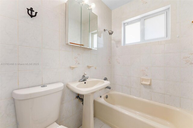 full bath with tile walls, shower / bath combination, and toilet