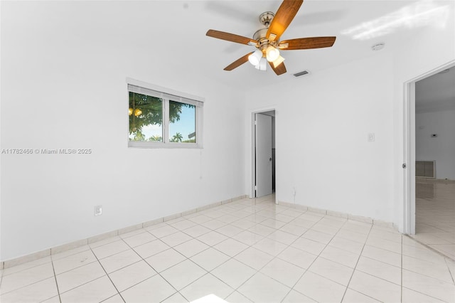 unfurnished room with a ceiling fan, visible vents, and light tile patterned floors