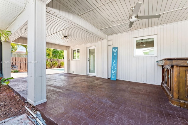 view of patio with a ceiling fan and fence
