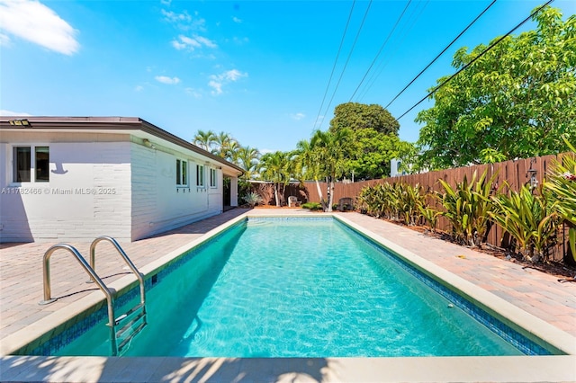 view of swimming pool featuring a fenced backyard and a fenced in pool