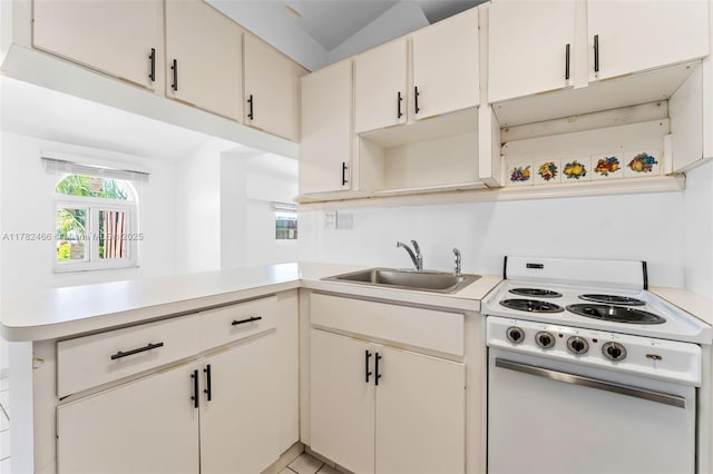 kitchen with light countertops, open shelves, a sink, white range with electric cooktop, and a peninsula