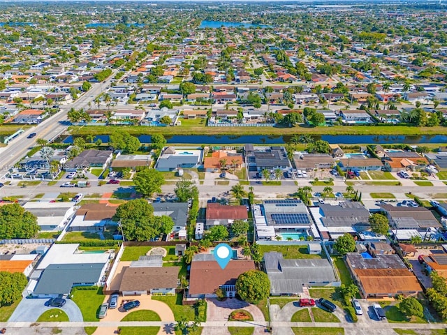 drone / aerial view featuring a residential view and a water view
