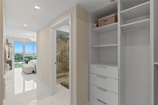 4779 Collins Ave Unit 1205, Miami Beach, FL 33140 - walk in closet with marble finish floor and a notable chandelier