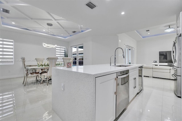 kitchen featuring a sink, visible vents, appliances with stainless steel finishes, and a raised ceiling