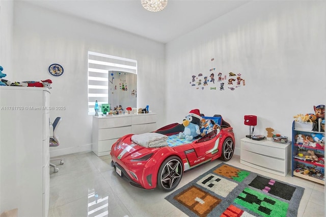 bedroom featuring baseboards and tile patterned flooring