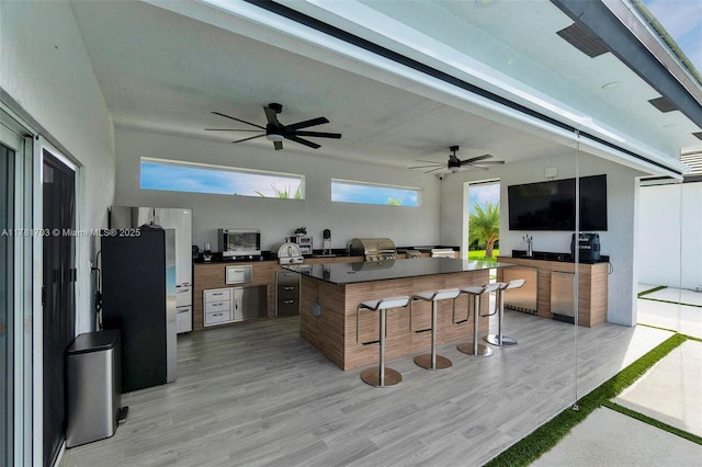 view of patio / terrace featuring a wooden deck, area for grilling, and ceiling fan