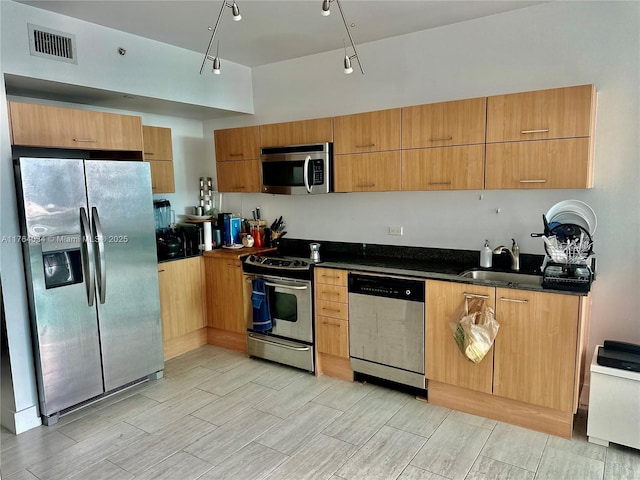 350 S Miami Ave Unit 2712, Miami, FL 33130 - kitchen featuring modern cabinets, light wood-style flooring, visible vents, appliances with stainless steel finishes, and a sink