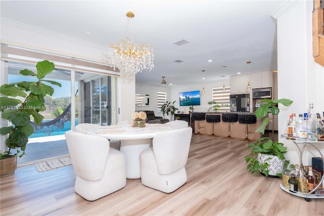 dining area with visible vents, light wood-style floors, a healthy amount of sunlight, recessed lighting, and ceiling fan with notable chandelier