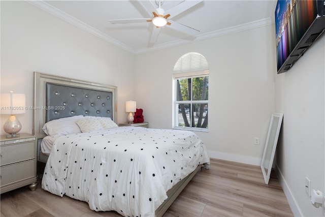 bedroom featuring ornamental molding, baseboards, and wood finished floors