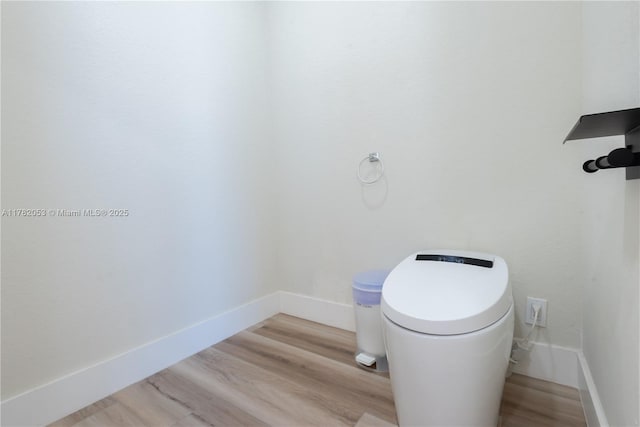 bathroom with baseboards and wood finished floors