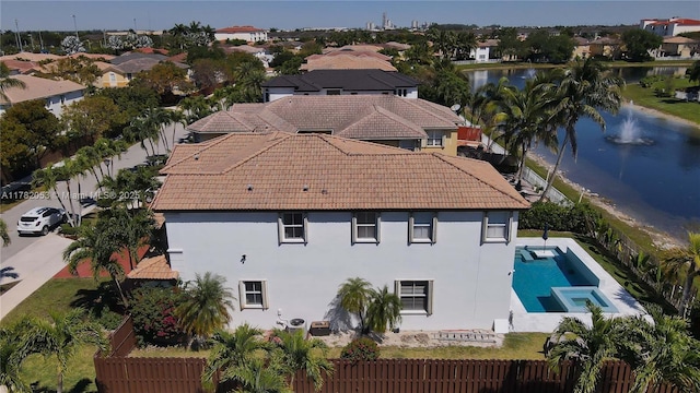 drone / aerial view with a water view and a residential view